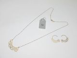 two gold necklaces and a pair of earrings with a price tag
