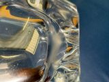 a close up of a glass object with a reflection of a building in it