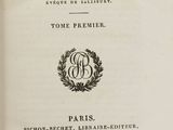 an open book with a black and white image of a clock on it