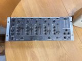 a close up of a dj controller on a wooden table