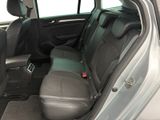 the back seats of a silver car with a black seat belt