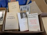 many books in a box that are sitting on a table