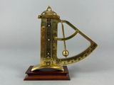 an old brass sundial on a wooden base with a white background