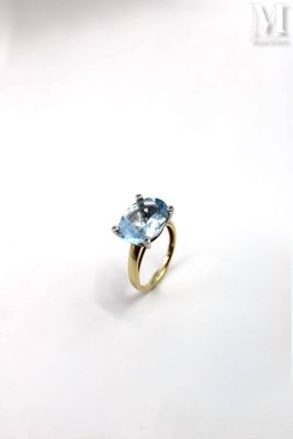 an image of a ring with a blue topaz stone