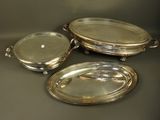 three silverplated serving dishes with handles and handles on a table