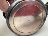 a person that is holding a silver plate with a handle