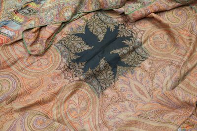 a close up picture of a scarf with a cross on it