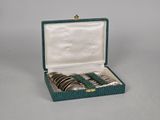 an image of a set of four silver and green spoons