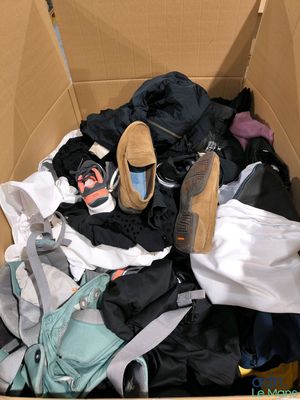 a cardboard box filled with clothes and a pair of shoes