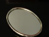 a mirror sitting on a table with a box in the background