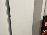 two white refrigerators next to each other in a kitchen