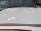 a car that has been left in the parking lot with the hood up