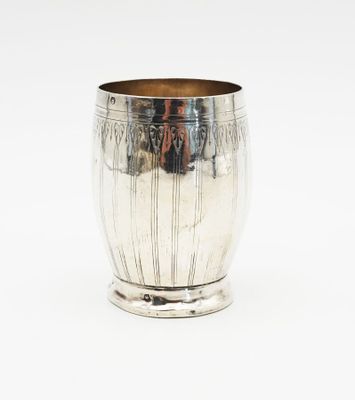 a silver cup that is sitting on a table