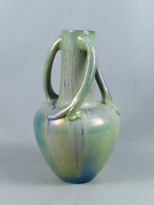 un vase bleu et vert posé sur une table