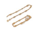 a pair of gold plated chain bracelets