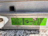 a close up of a piece of metal with a green sticker on it