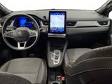the interior of a car with a tablet on the dashboard