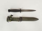 two knives are laying side by side on a white surface