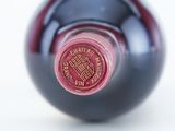 a close up of a wine bottle with a red label