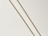 a gold necklace with a chain that has a heart shaped pendant on it