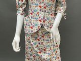a mannequin dressed in a floral print dress and jacket