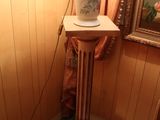 a lamp that is sitting on a pedestal in a room