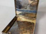 an old silver box with a mirror in it on a white surface