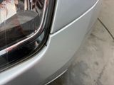 a close up of a car ' s headlight on a street