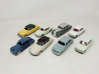 several toy cars are lined up in a row on a white surface