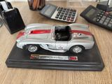 a toy car sitting on a desk next to a calculator