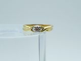 an image of a diamond ring sitting on top of a clear glass
