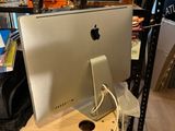a computer on a desk in a room with a lot of shelves
