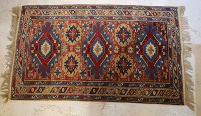 an old rug with a red, blue, and yellow design on it