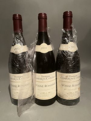 three bottles of wine wrapped in plastic sitting on a table
