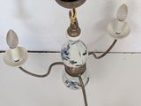 a chandelier that has a glass light fixture on it