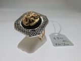 an image of a gold and black ring with a lion head on it