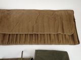 a leather case with a knife and a knife rest on a table
