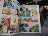 a comic book open on a table with comics on it