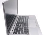 a silver laptop computer sitting on top of a white table