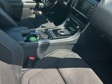 the interior of a car with a steering wheel and dashboard controls