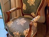 a chair that is next to a table with a lamp on it