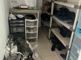 a room that has a lot of clothes on the shelves