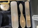 a black box with a pair of shoes and a pair of spoons