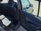 a black car with its door open on the side of the road