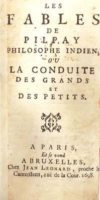 an old book with writing on it sitting on a table