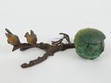 a figurine of a cabbage and two birds on a branch