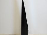 a black cone shaped object sitting on the floor