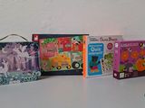 several children ' s books are lined up on a white surface