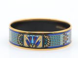 a close up of a ring with blue and yellow designs