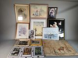 many framed pictures on a table with a lot of them
